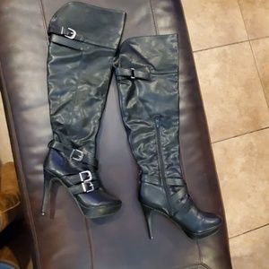 Over the knee black faux leather boots.